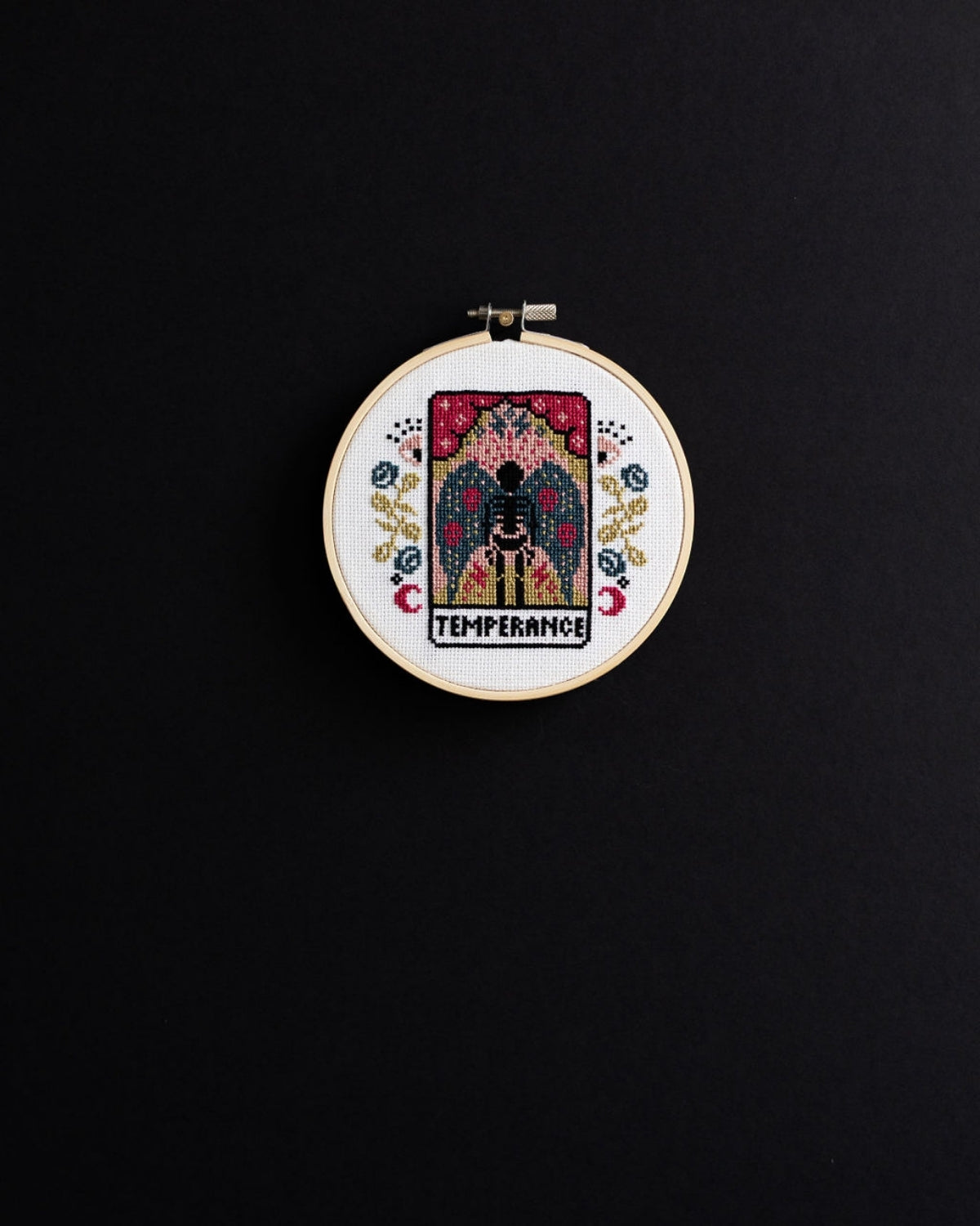 temperance tarot cross stitch design on a black background