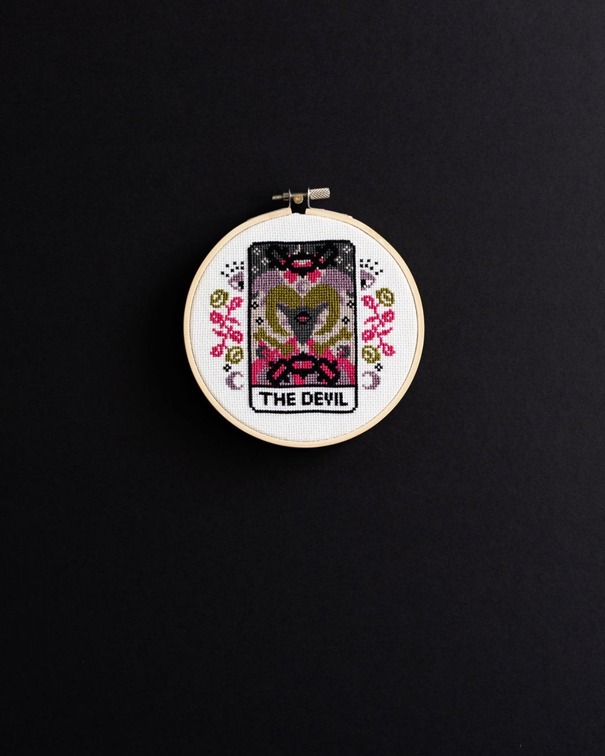 The devil tarot cross stitch design on a black background
