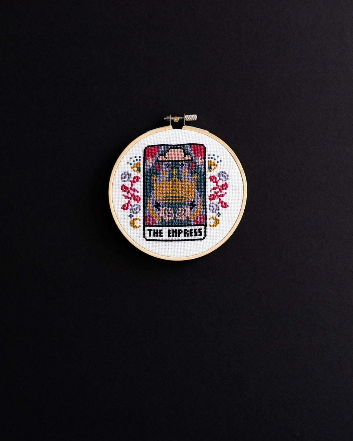 The empress tarot cross stitch design on a black background