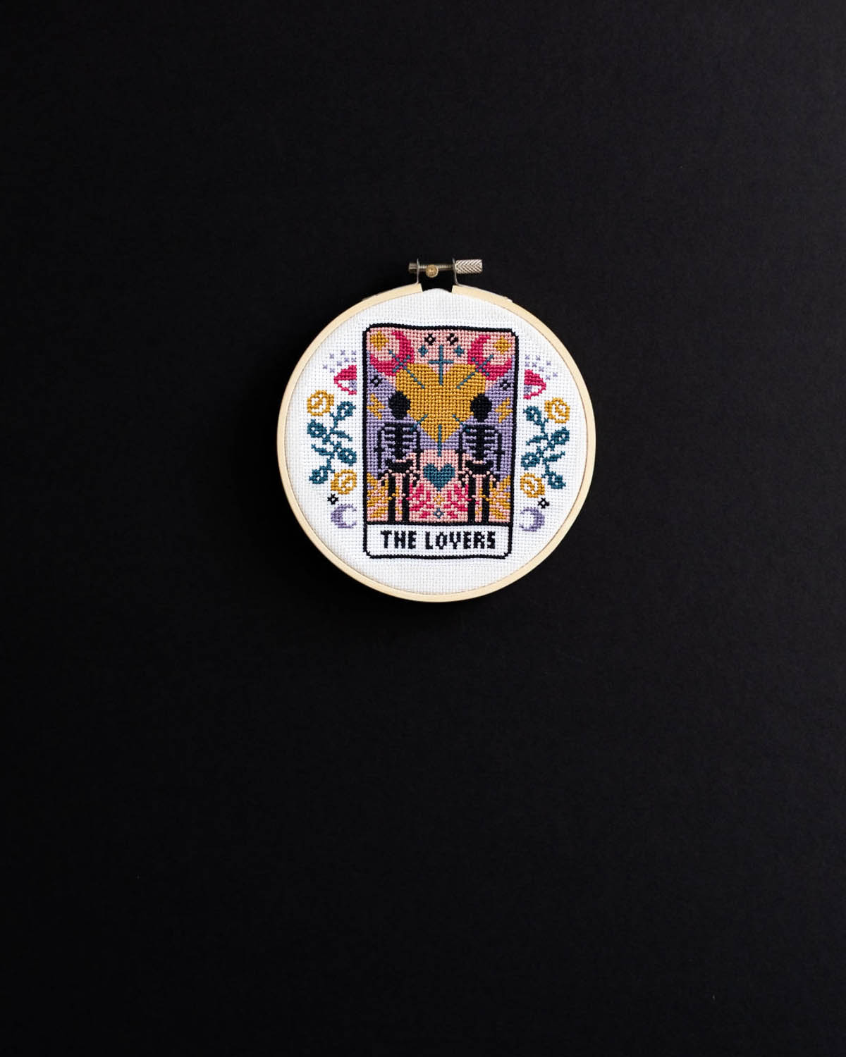 The lovers tarot cross stitch design on a black background