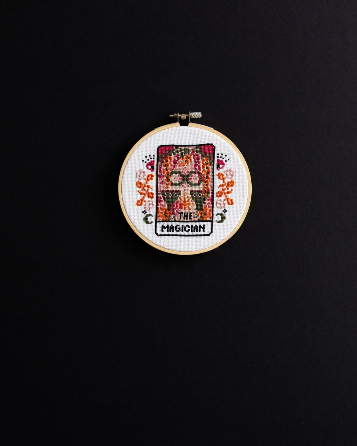 The magician tarot cross stitch design on a black background