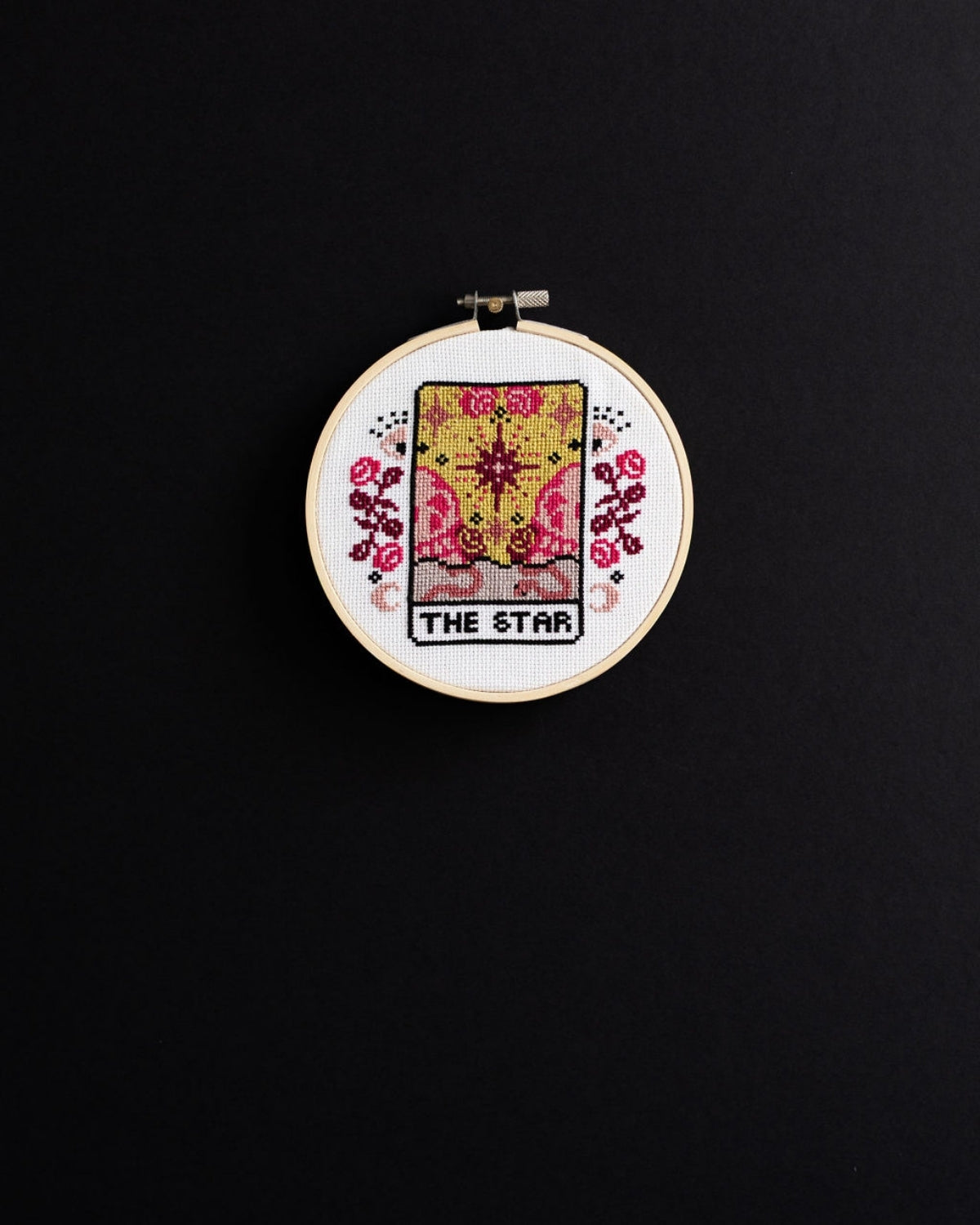The star tarot cross stitch design on a black background