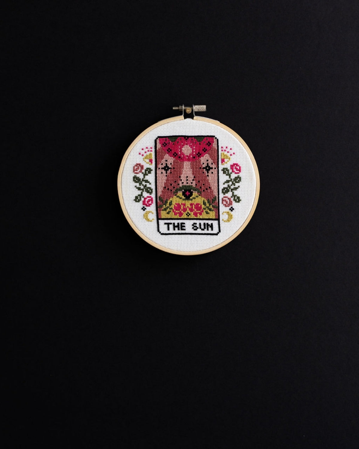 The sun tarot cross stitch design on a black background