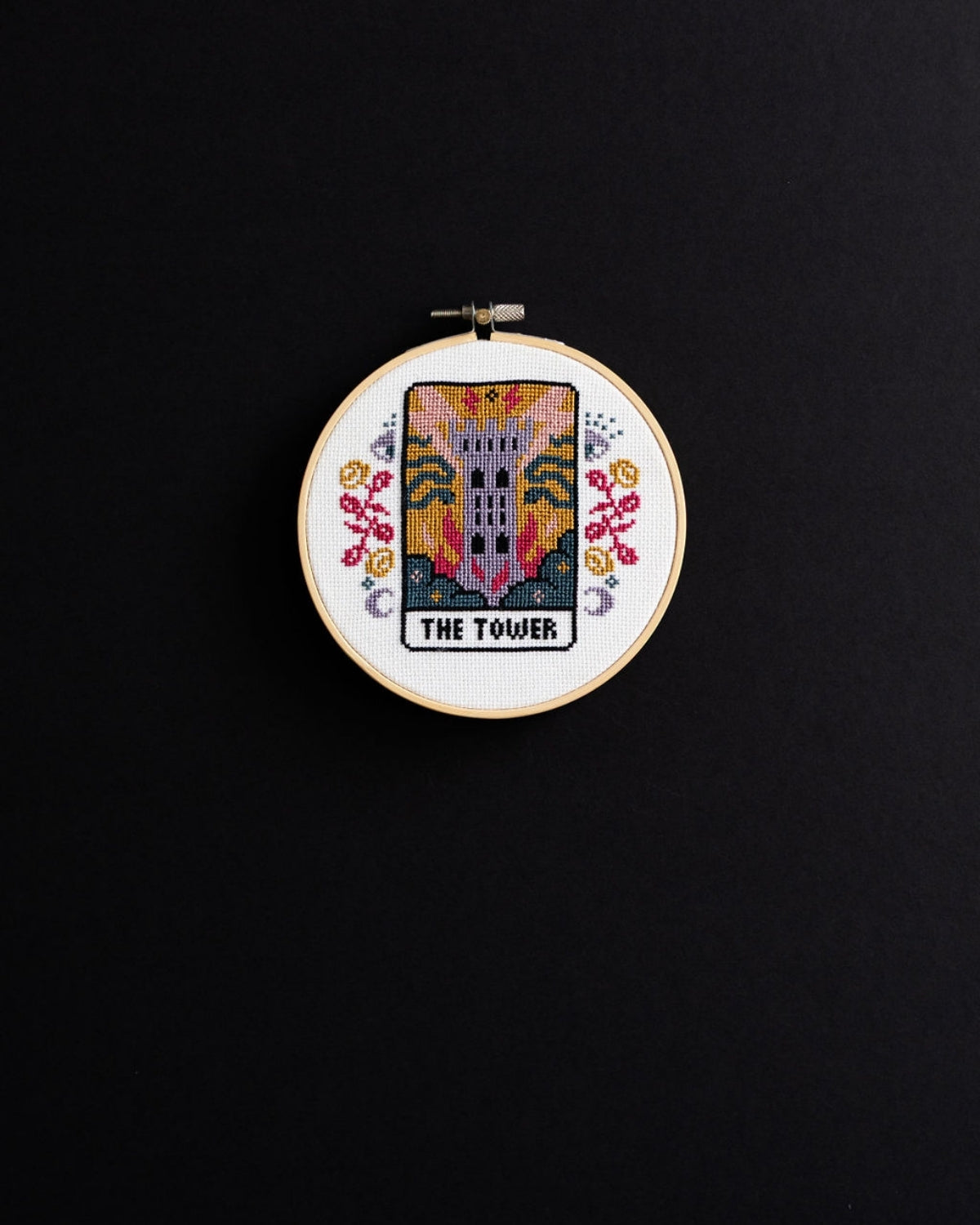 The tower tarot cross stitch design on a black background