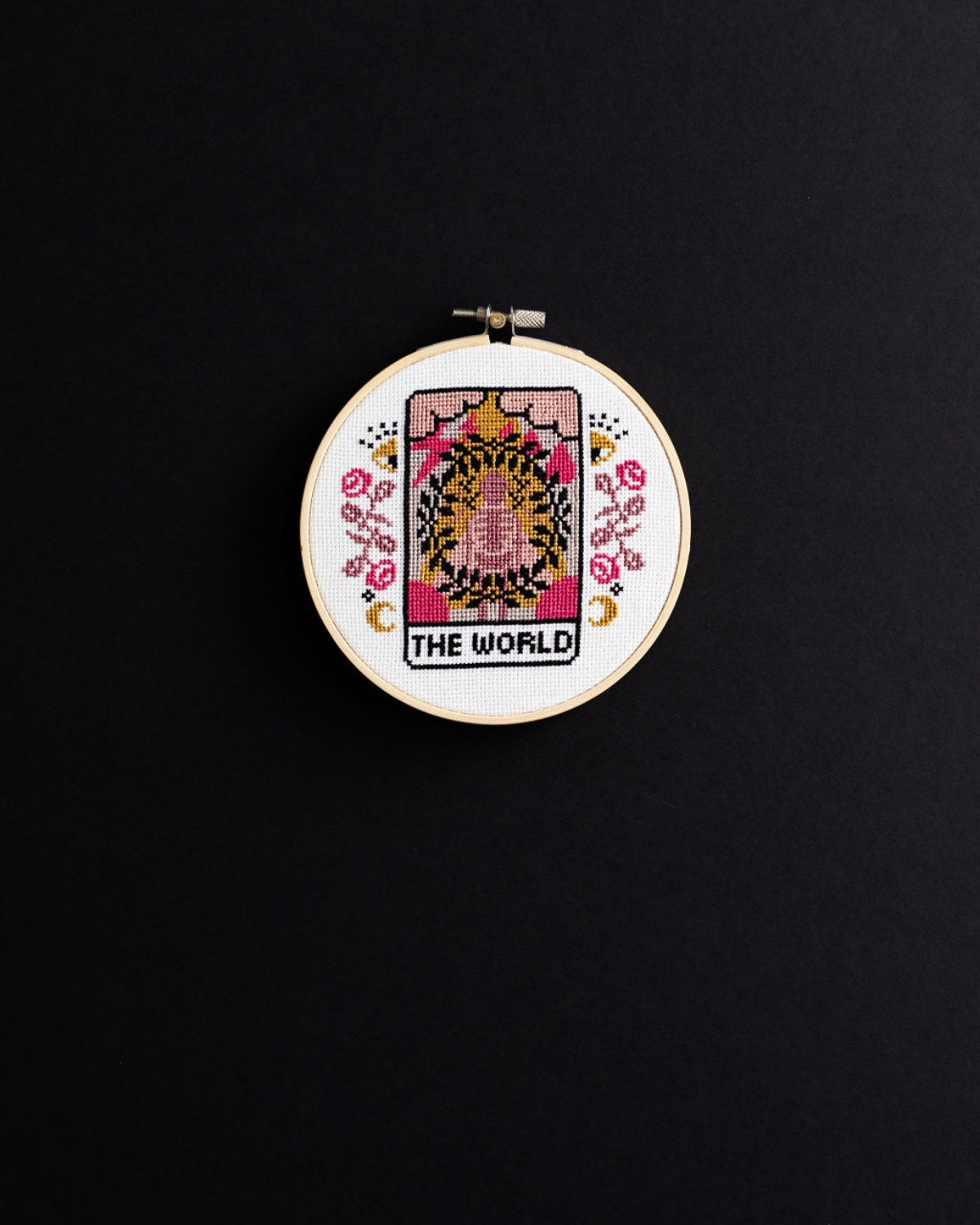 The world tarot cross stitch design on a black background